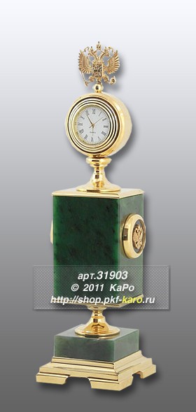 Часы &quot;Герб&quot; из нефрита Часы "Герб", выполненные из нефрита и металла. Кварцевый часовой механизм. На фото типовое изделие, оригинал может отличаться по размеру и весу (в пределах 10%), цвету, рисунку камня. 